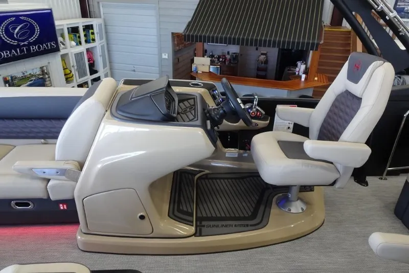 Slide: The Image of 2026 Harris Sunliner 250 Sport boat interior with modern helm and comfortable seating. - 15
