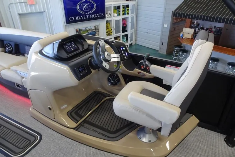 Slide: The Image of 2026 Harris Sunliner 250 Sport boat interior with modern helm and comfortable seating. - 16