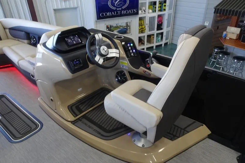 Slide: The Image of 2026 Harris Sunliner 250 Sport boat interior with modern helm and comfortable seating. - 17