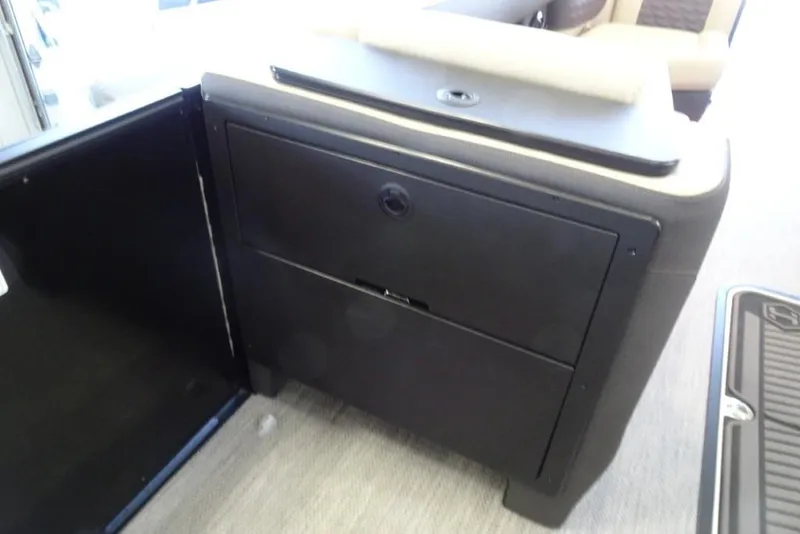 Slide: The Image of 2026 Harris Sunliner 250 Sport interior storage compartment with sleek black finish. - 20