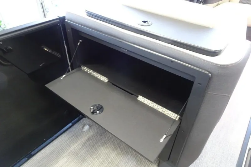 Slide: The Image of Open storage compartment in 2026 Harris Sunliner 250 Sport boat interior. - 21