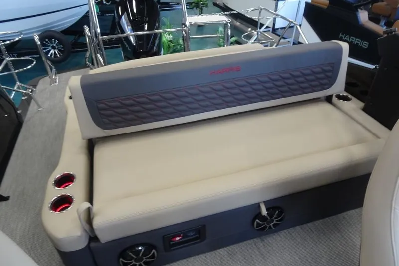 Slide: The Image of 2026 Harris Sunliner 250 Sport boat interior with beige seating and cup holders. - 23