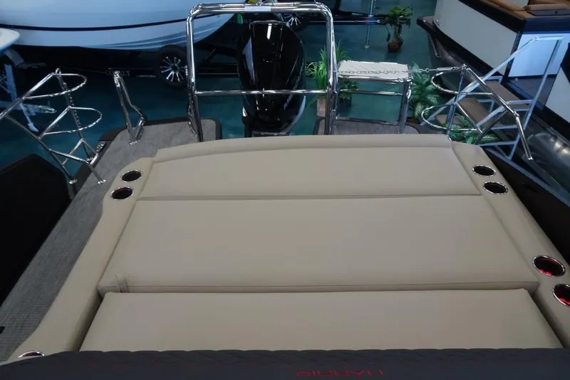 Slide: The Image of 2026 Harris Sunliner 250 Sport boat interior with beige seating and chrome accents. - 25