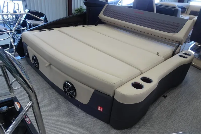 Slide: The Image of 2026 Harris Sunliner 250 Sport boat interior with beige seating and cup holders. - 27