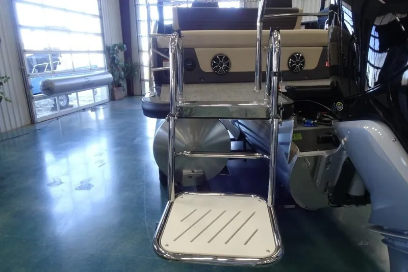 Slide: The Image of 2026 Harris Sunliner 250 Sport boat ladder and deck in showroom. - 5