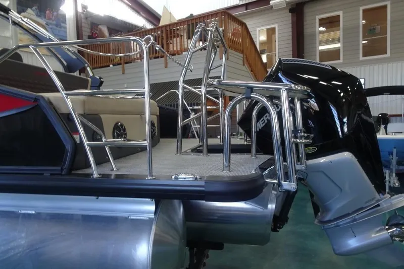 Slide: The Image of 2026 Harris Sunliner 250 Sport pontoon boat with sleek design and powerful outboard motor. - 7