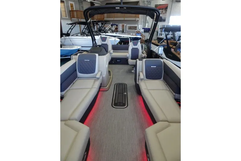 Slide: The Image of 2026 Harris Sunliner 250 Sport interior with luxurious seating and ambient lighting. - 9