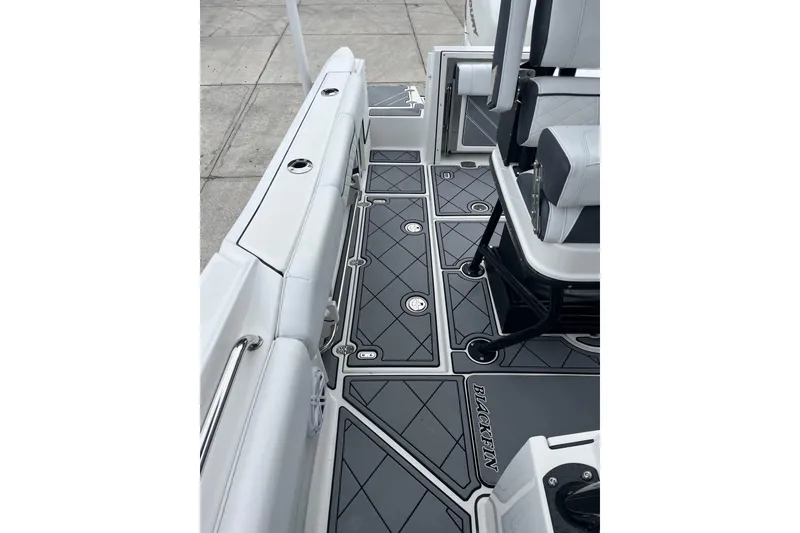 Slide: The Image of 2021 Blackfin 252 CC boat interior with sleek seating and modern flooring design. - 20