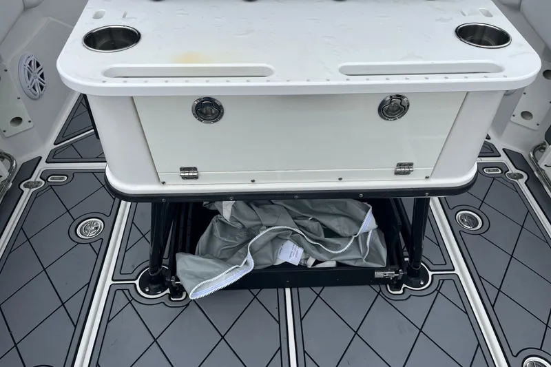 Slide: The Image of 2021 Blackfin 252 CC boat interior with storage compartment and cup holders. - 25