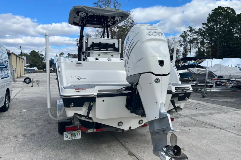 Slide: The Image of 2021 Blackfin 252 CC boat with powerful outboard motor, parked outdoors. - 3