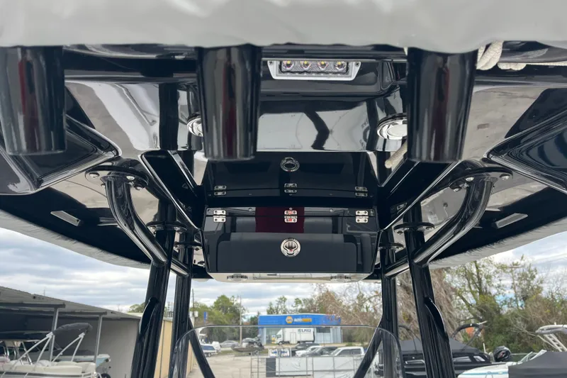 Slide: The Image of 2021 Blackfin 252 CC boat console with sleek black finish and overhead storage. - 7