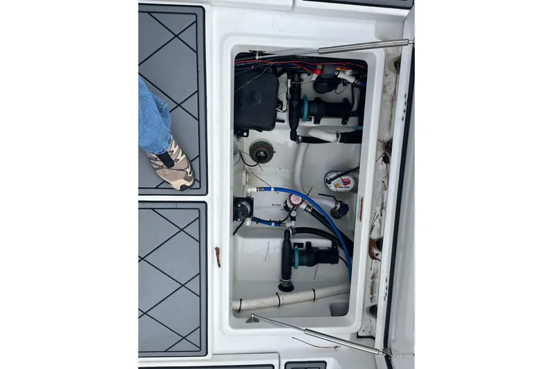 Slide: The Image of 2021 Blackfin 252 CC boat interior showing mechanical components and deck flooring. - 9