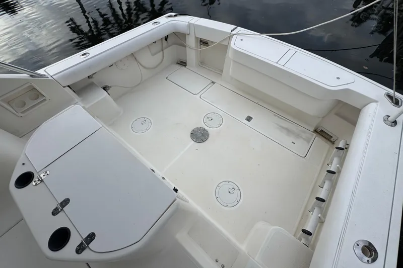Slide: The Image of 1995 Pursuit 3000 Express boat deck with storage compartments and seating. - 15