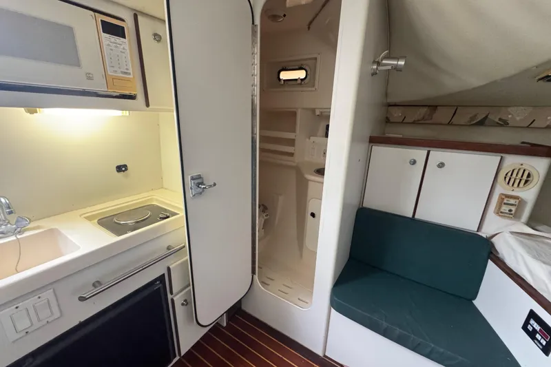 Slide: The Image of 1995 Pursuit 3000 Express cabin interior with kitchenette and seating area. - 27