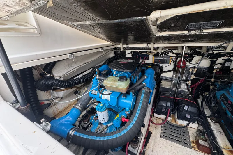 Slide: The Image of Engine compartment of a 1995 Pursuit 3000 Express boat, showcasing detailed mechanical components. - 34