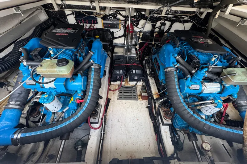 Slide: The Image of 1995 Pursuit 3000 Express engine compartment with dual blue marine engines. - 35
