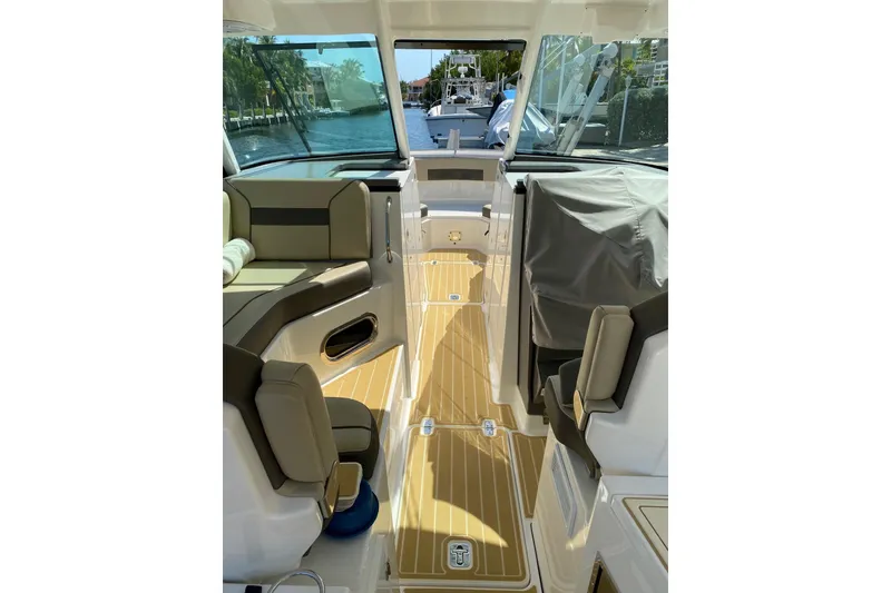 Slide: The Image of Interior of 2020 Pursit DC 325 boat with seating and wooden flooring. - 12