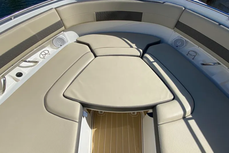 Slide: The Image of Luxurious seating area on 2020 Pursit DC 325 boat, featuring beige cushions and speakers. - 14