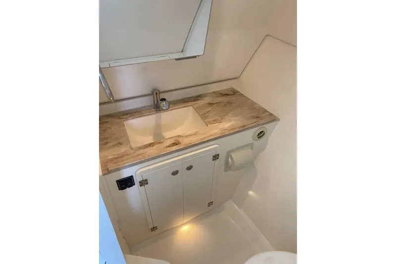 Slide: The Image of Compact bathroom in 2020 Pursit DC 325 boat with sink and storage cabinet. - 18