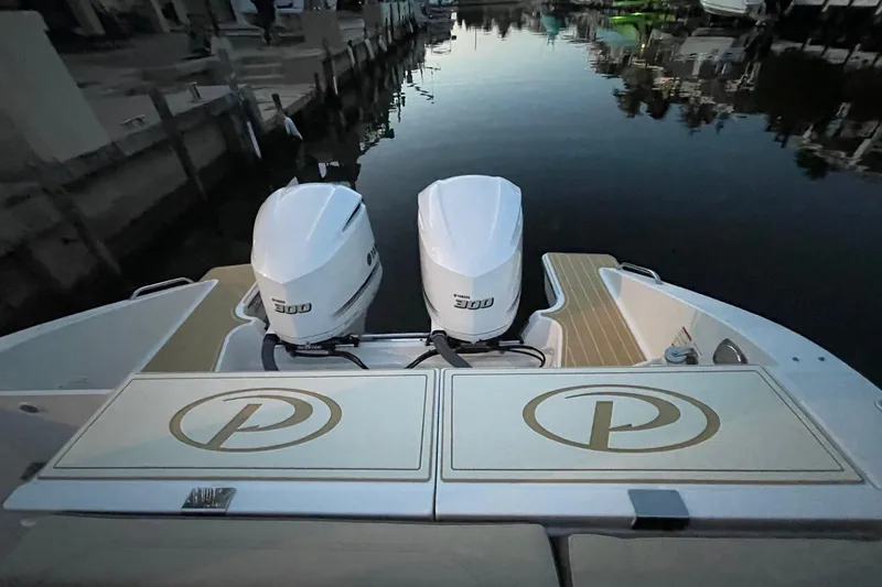 Slide: The Image of 2020 Pursit DC 325 boat with twin 300 engines docked at marina. - 9