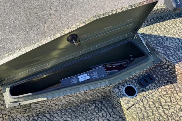 Slide: The Image of Open storage compartment in 2026 Vexus ACX 2000 boat with textured interior. - 13