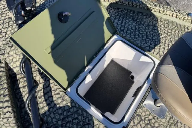 Slide: The Image of Open storage compartment in 2026 Vexus ACX 2000 boat, featuring textured flooring and seating. - 18