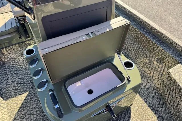 Slide: The Image of 2026 Vexus ACX 2000 boat console with open storage compartment and cup holders. - 19