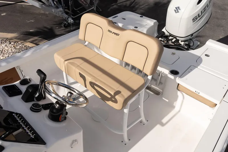 Slide: The Image of 2026 Sea Pro 210 Bay boat interior with steering wheel and seating. - 11