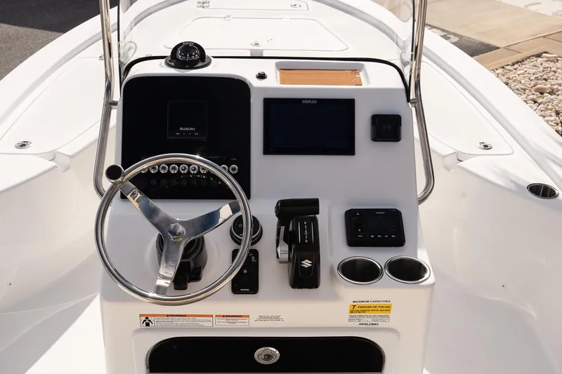 Slide: The Image of 2026 Sea Pro 210 Bay boat console with steering wheel and navigation controls. - 13