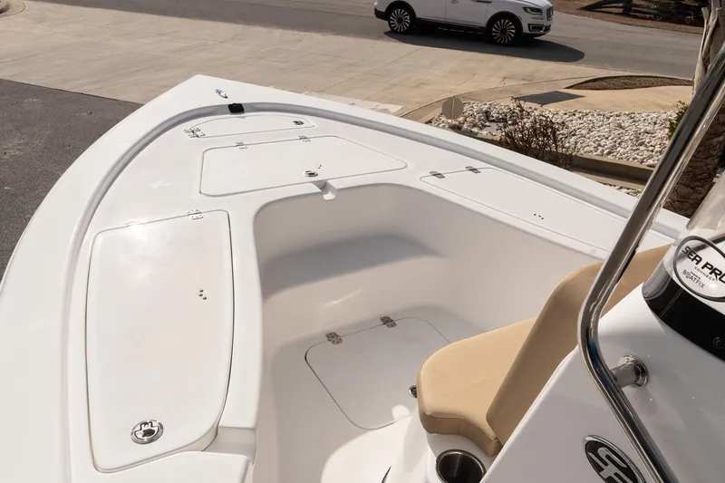 Slide: The Image of 2026 Sea Pro 210 Bay boat interior with seating and storage compartments. - 14
