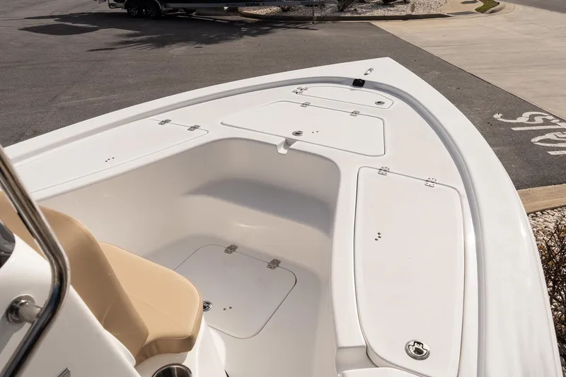 Slide: The Image of 2026 Sea Pro 210 Bay boat deck with storage compartments and seating. - 15