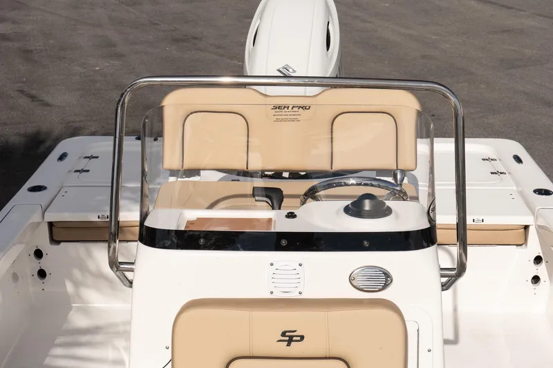 Slide: The Image of 2026 Sea Pro 210 Bay boat console with steering wheel and beige seating. - 19