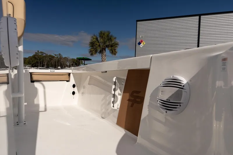 Slide: The Image of 2026 Sea Pro 210 Bay boat interior with speaker and seating under clear sky. - 20