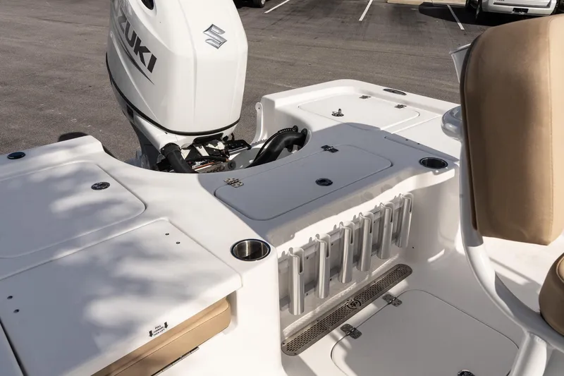 Slide: The Image of 2026 Sea Pro 210 Bay boat with Suzuki engine, featuring rod holders and storage compartments. - 7