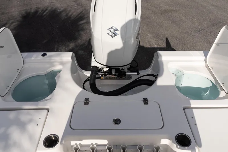 Slide: The Image of 2026 Sea Pro 210 Bay boat with Suzuki outboard motor and open storage compartments. - 9