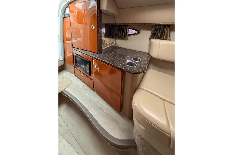 Slide: The Image of 2004 Formula 330 Sun Sport interior with kitchenette, microwave, and seating area. - 15