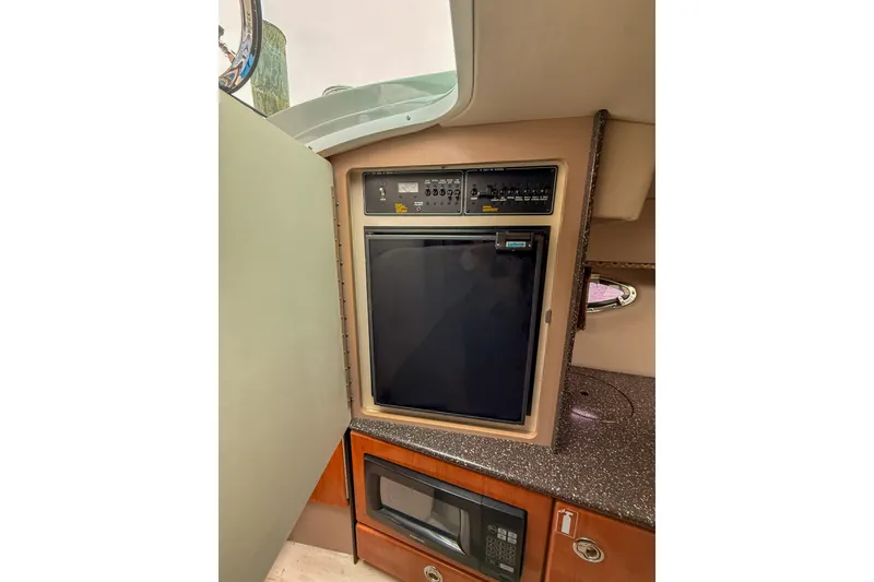 Slide: The Image of Interior of 2004 Formula 330 Sun Sport with fridge and microwave. - 17