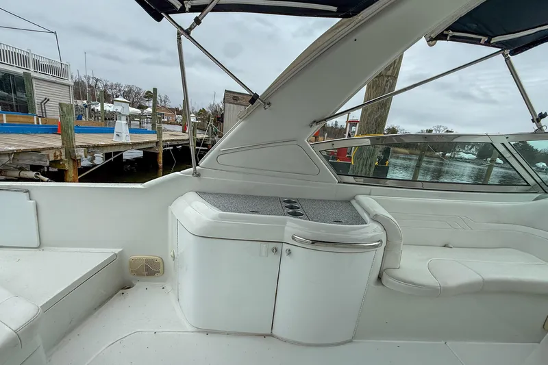 Slide: The Image of 2004 Formula 330 Sun Sport boat interior with seating and dockside view. - 18