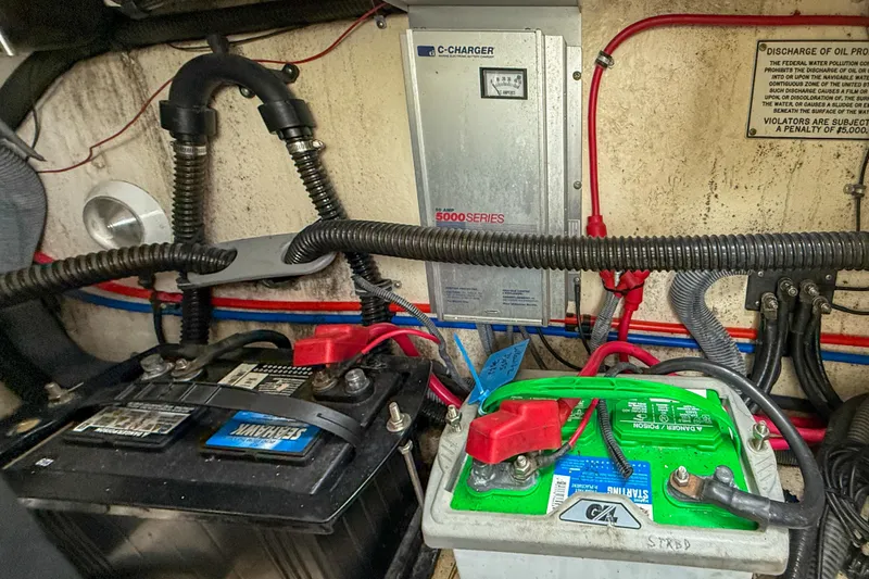 Slide: The Image of Engine compartment of a 2004 Formula 330 Sun Sport with batteries and wiring. - 23