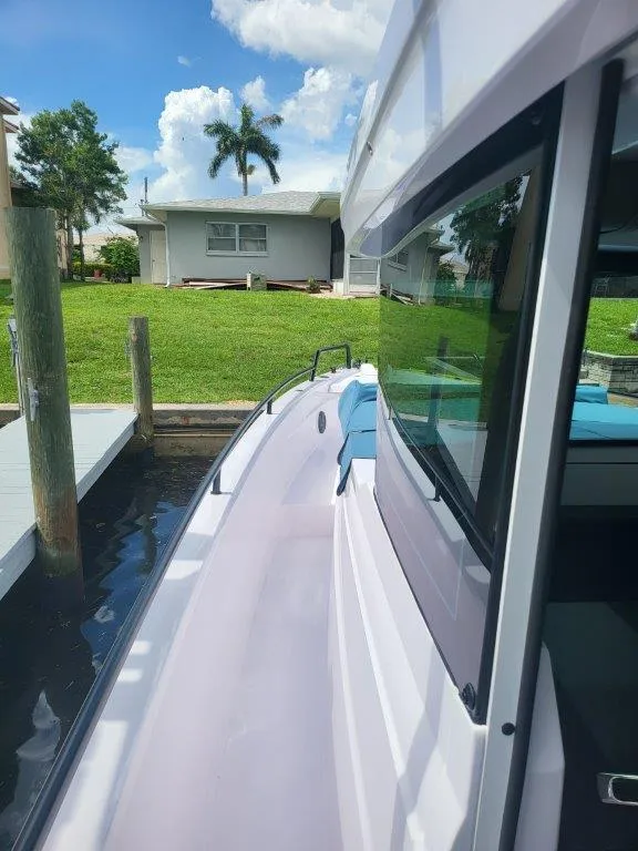 Slide: The Image of 2024 Axopar 37 XC CROSS CABIN docked, showcasing sleek design and modern features. - 18