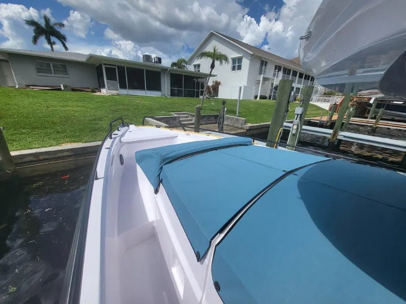 Slide: The Image of 2024 Axopar 37 XC CROSS CABIN docked near waterfront homes. - 19