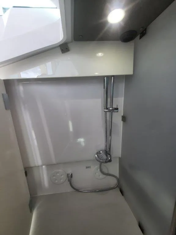 Slide: The Image of 2024 Axopar 37 XC CROSS CABIN interior shower area with modern fixtures. - 30