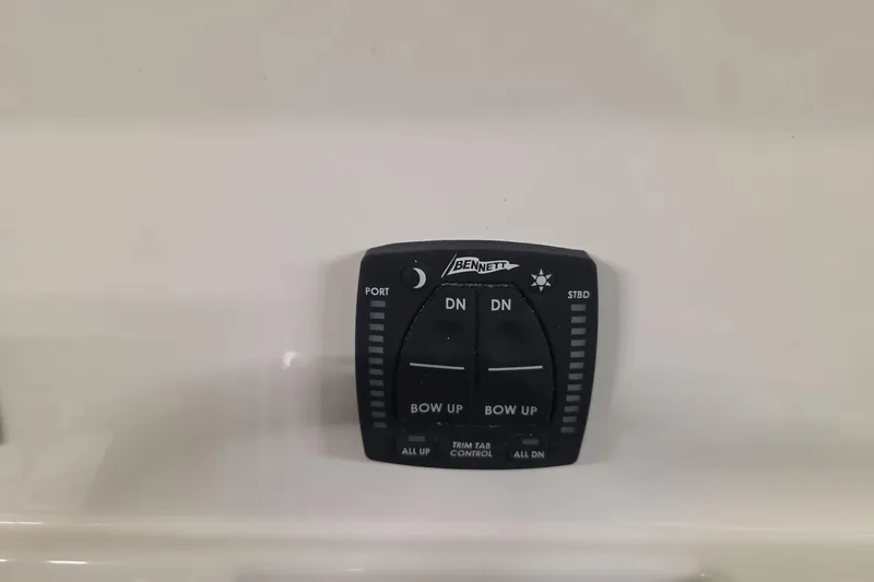 Slide: The Image of Bennett trim tab control on 2026 Sailfish 272 CC boat dashboard. - 11