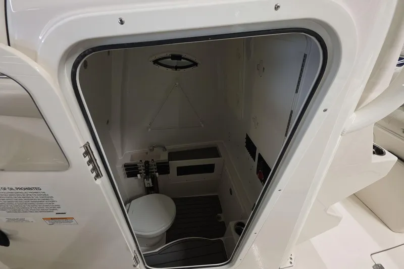Slide: The Image of 2026 Sailfish 272 CC boat interior with compact marine toilet and storage area. - 18