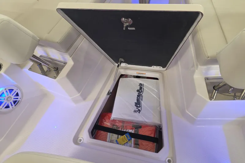 Slide: The Image of Open storage compartment on 2026 Sailfish 272 CC boat with cooler and life jackets. - 26