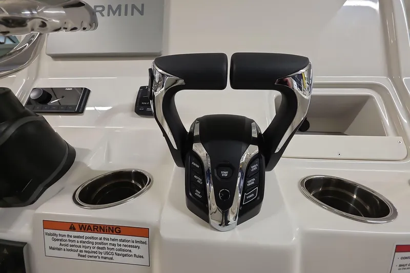 Slide: The Image of Control panel of 2026 Sailfish 272 CC boat with modern throttle and warning label. - 27
