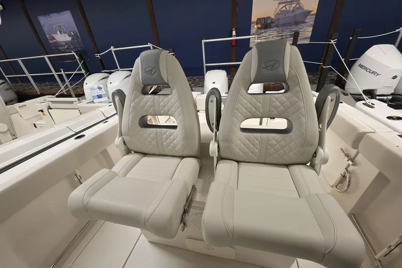 Slide: The Image of Luxury seating on 2026 Sailfish 272 CC boat, featuring quilted upholstery and modern design. - 28