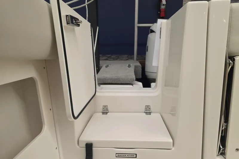 Slide: The Image of 2026 Sailfish 272 CC boat interior, featuring seacock access and open storage compartment. - 31
