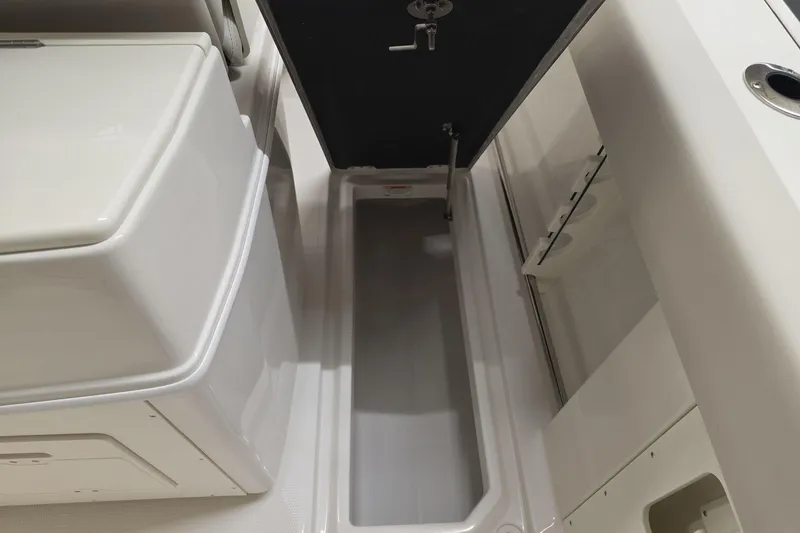 Slide: The Image of Interior storage compartment of 2026 Sailfish 272 CC boat, featuring sleek design and ample space. - 9