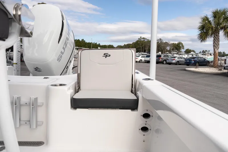 Slide: The Image of 2025 Sea Pro 230 Bay boat with Suzuki engine, parked near palm trees and cars. - 12